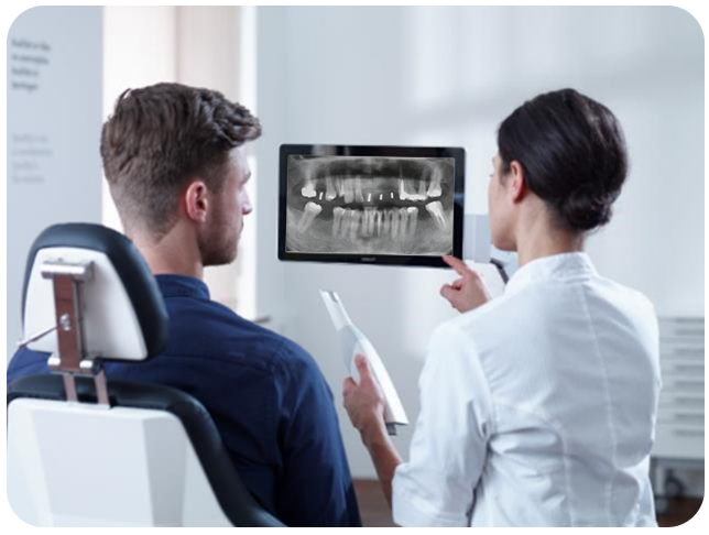 Dentist explaining a panoramic X-ray during a dental implant consultation at Uzmanlar Dental Clinic Istanbul